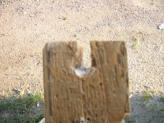 Пуля "NikA" после 120 мм сосновых досок,  пробила дыру в последнем брусе. Вид по ходу пули.